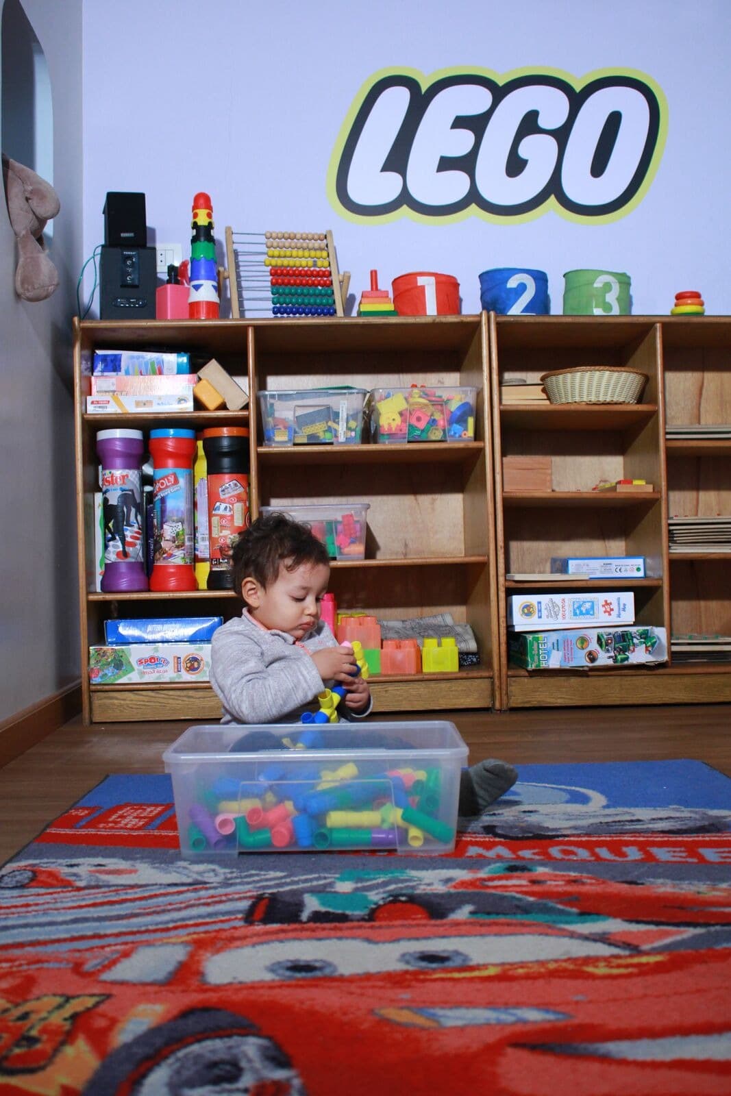 A child choosing from the LEGO shelves