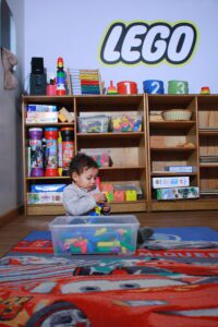 Superkids nursery, kid playing with lego